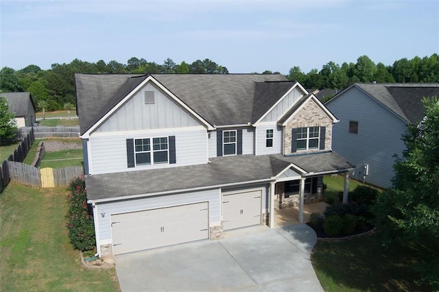 9120 Alden Dr, Locust Grove, GA 30248 - view of front of property with board and batten siding, concrete driveway, stone siding, and an attached garage