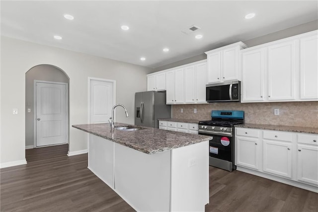 9120 Alden Dr, Locust Grove, GA 30248 - kitchen featuring appliances with stainless steel finishes, a sink, an island with sink, dark wood-style floors, and stone countertops