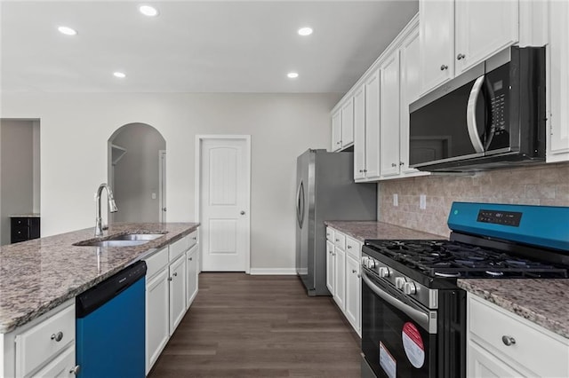 9120 Alden Dr, Locust Grove, GA 30248 - kitchen featuring stainless steel appliances, a sink, arched walkways, white cabinetry, and recessed lighting