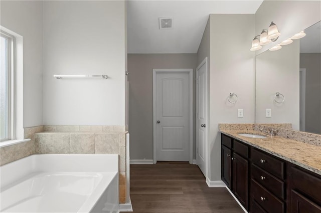 9120 Alden Dr, Locust Grove, GA 30248 - full bath with a bath, wood finished floors, and vanity