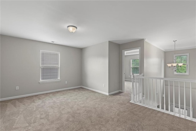9120 Alden Dr, Locust Grove, GA 30248 - carpeted spare room featuring baseboards, a chandelier, and ornamental molding