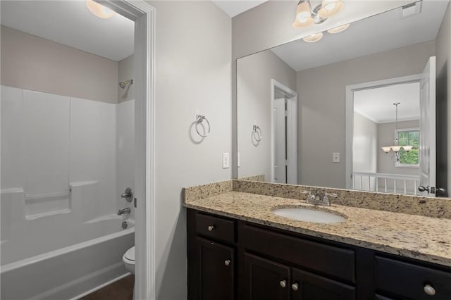 9120 Alden Dr, Locust Grove, GA 30248 - bathroom with toilet, vanity, shower / bathtub combination, and a chandelier
