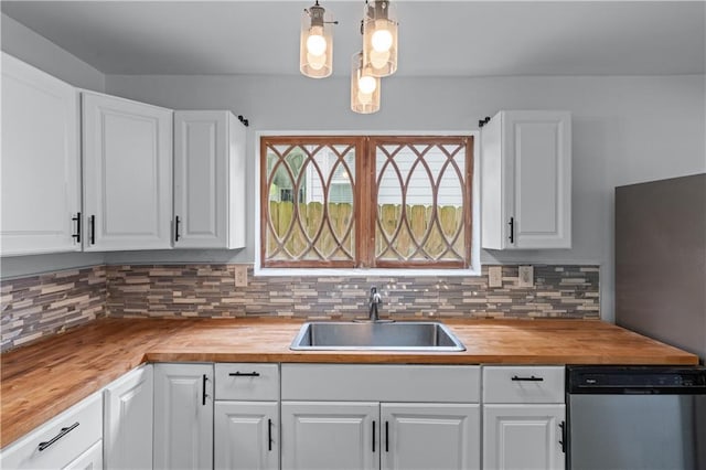 kitchen with stainless steel dishwasher, wooden counters, and a sink