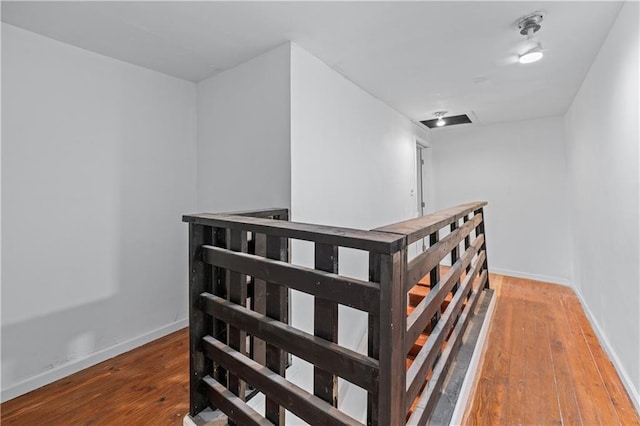 stairway with baseboards and hardwood / wood-style floors
