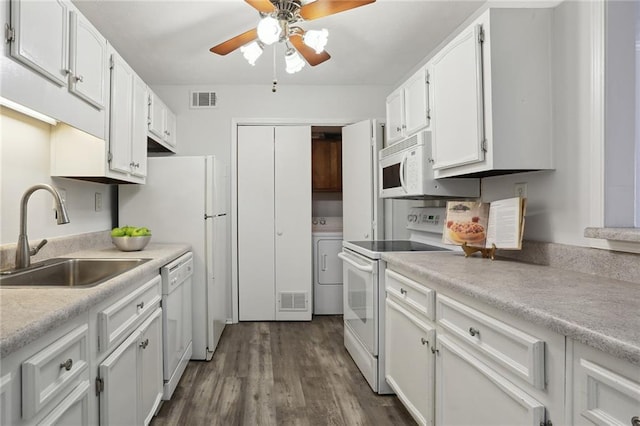 kitchen with sink, white cabinetry, dark hardwood / wood-style flooring, white appliances, and washer / clothes dryer