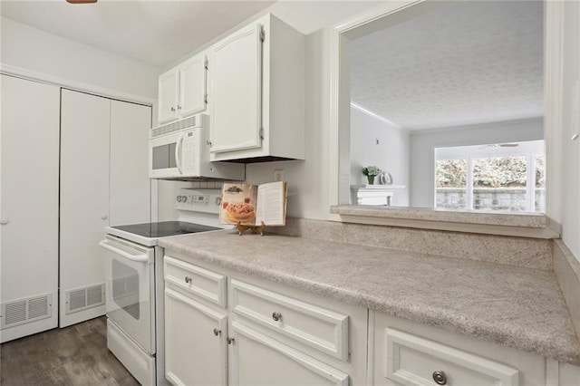 kitchen featuring white cabinetry, white appliances, dark hardwood / wood-style flooring, and ceiling fan