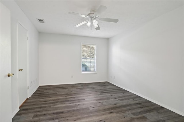 spare room featuring dark hardwood / wood-style floors and ceiling fan