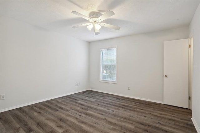 spare room featuring ceiling fan and dark hardwood / wood-style floors