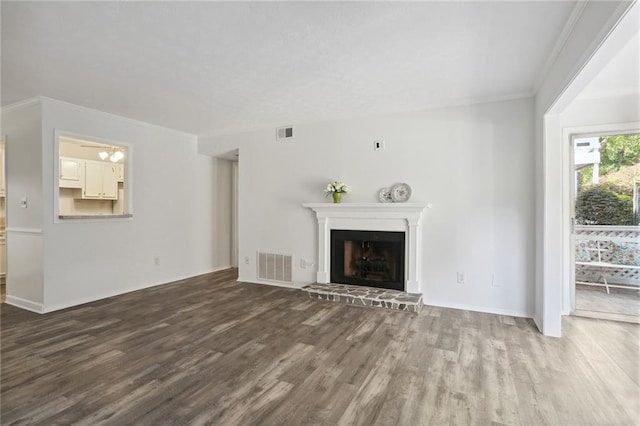 unfurnished living room with hardwood / wood-style flooring and ornamental molding