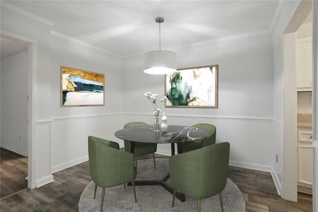 dining area with ornamental molding and dark hardwood / wood-style flooring