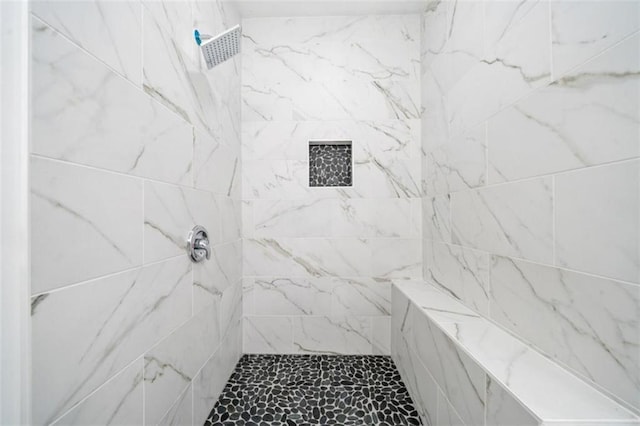 bathroom with a tile shower