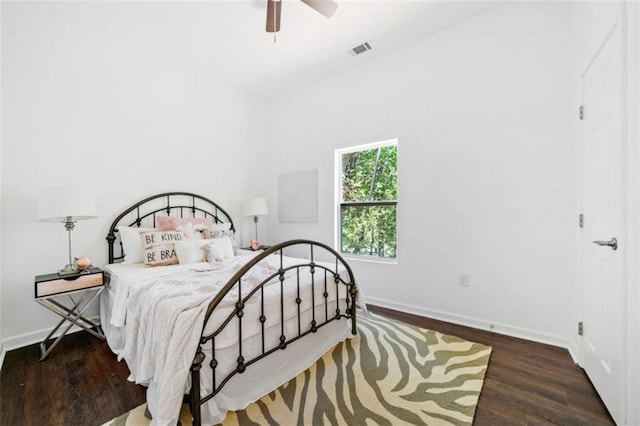 bedroom featuring wood finished floors, visible vents, and baseboards