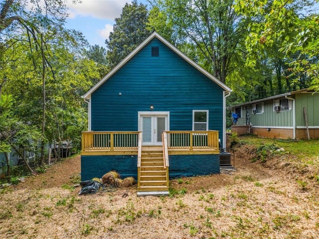 rear view of property featuring stairway, french doors, and a wooden deck