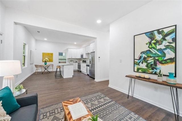 living room with recessed lighting, baseboards, and dark wood-style flooring