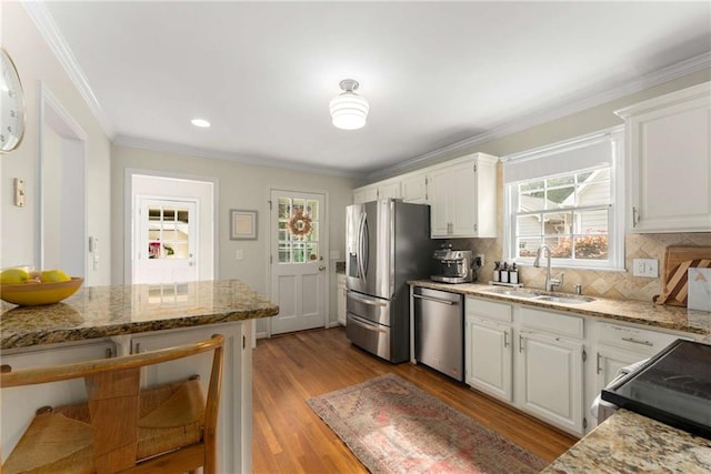 999 Seaboard Ave NW, Atlanta, GA 30318 - kitchen featuring appliances with stainless steel finishes, tasteful backsplash, white cabinetry, light stone countertops, and plenty of natural light