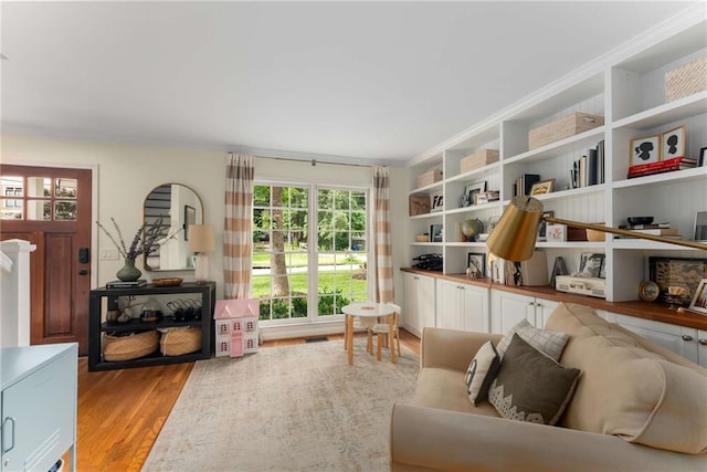 999 Seaboard Ave NW, Atlanta, GA 30318 - living room featuring light wood-style floors and crown molding
