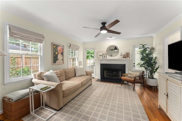 999 Seaboard Ave NW, Atlanta, GA 30318 - living area with crown molding, a ceiling fan, healthy amount of natural light, a fireplace with flush hearth, and light wood finished floors