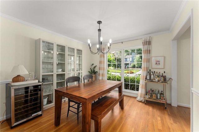 999 Seaboard Ave NW, Atlanta, GA 30318 - dining room with wine cooler, a chandelier, crown molding, and wood finished floors