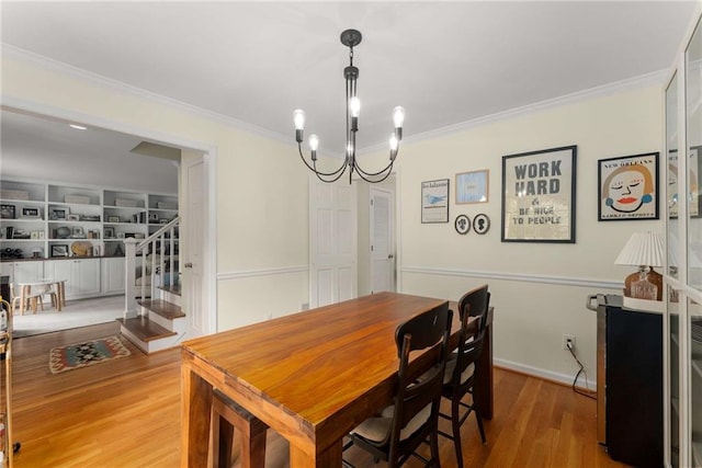 999 Seaboard Ave NW, Atlanta, GA 30318 - dining room featuring stairway, wood finished floors, ornamental molding, and a chandelier