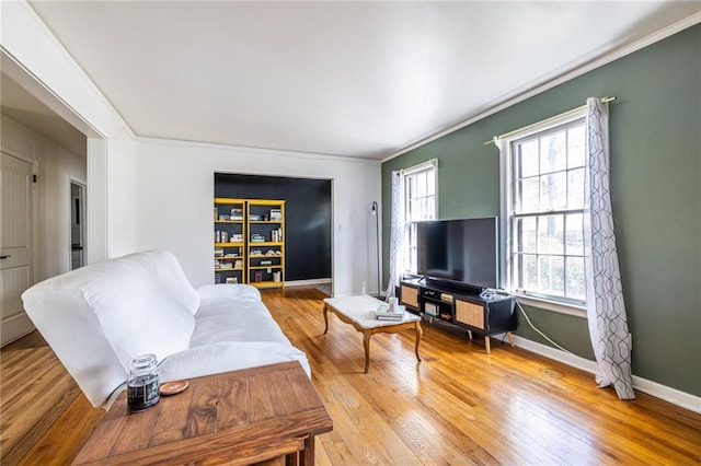 living room featuring hardwood / wood-style flooring and ornamental molding