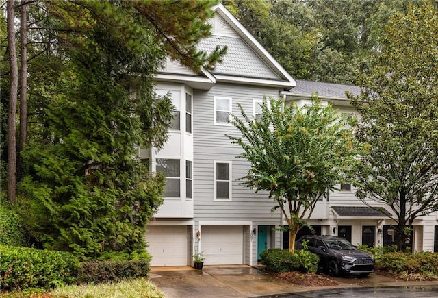 multi unit property with concrete driveway and an attached garage