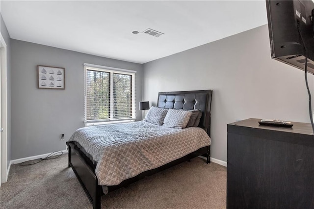 bedroom featuring visible vents, baseboards, and carpet