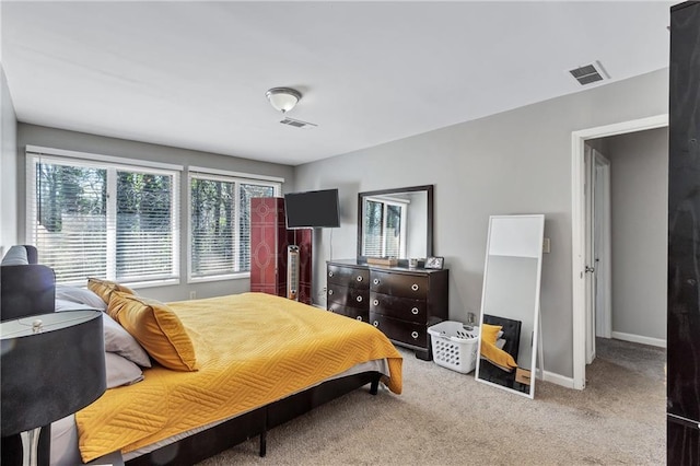 bedroom featuring visible vents, baseboards, and carpet