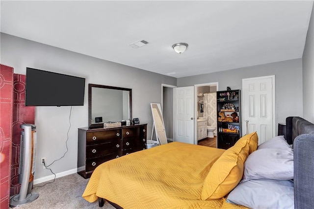 bedroom featuring visible vents, baseboards, ensuite bathroom, and carpet flooring