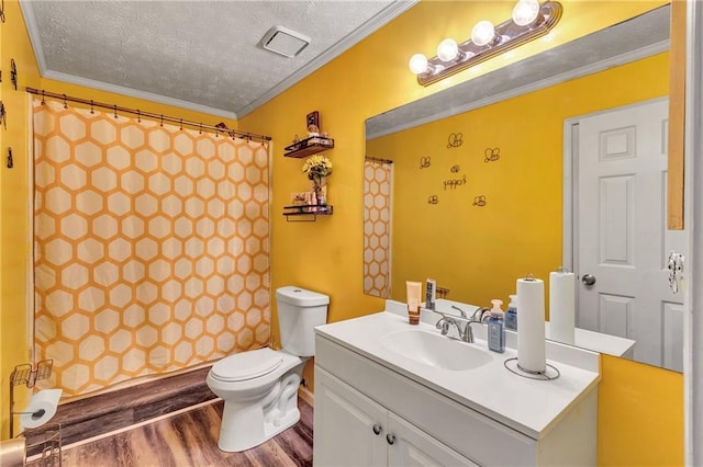 bathroom featuring a textured ceiling, vanity, wood finished floors, and ornamental molding