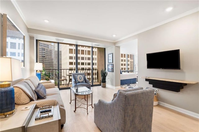 living room featuring ornamental molding and light hardwood / wood-style floors