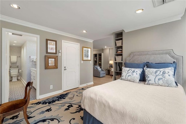 bedroom featuring crown molding and ensuite bath