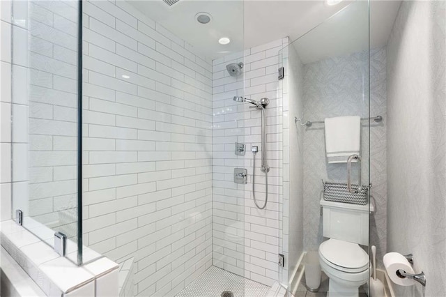 bathroom with toilet and a shower with shower door