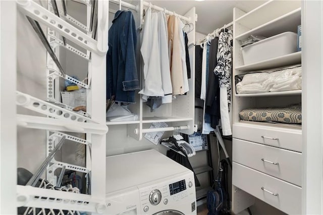 spacious closet featuring washer / dryer