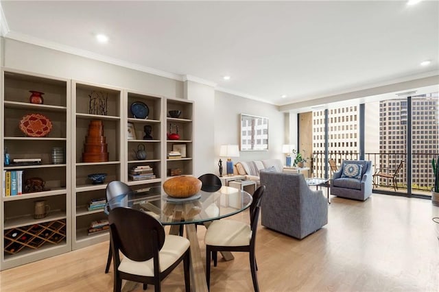 dining room with expansive windows, ornamental molding, and light wood-type flooring