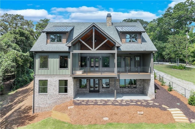 back of house featuring a balcony and a patio area