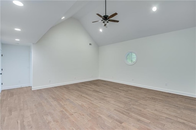 empty room featuring lofted ceiling, ceiling fan, and light hardwood / wood-style flooring