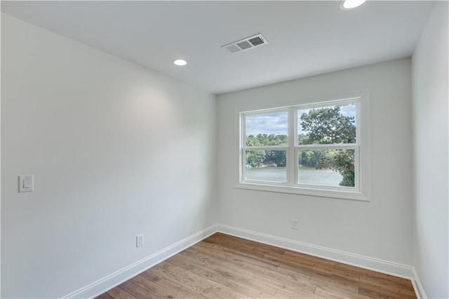 spare room featuring light hardwood / wood-style floors