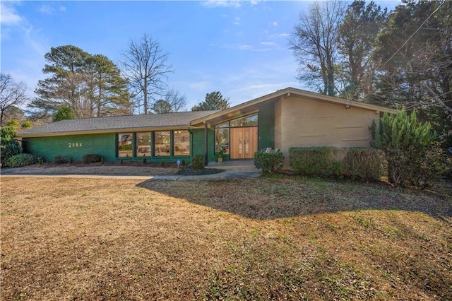 ranch-style home with a front lawn