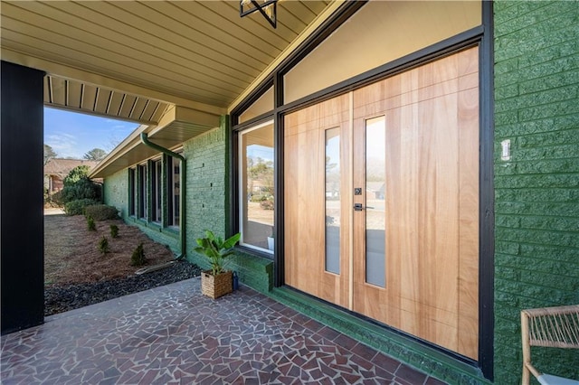 view of property exterior featuring a patio area and french doors