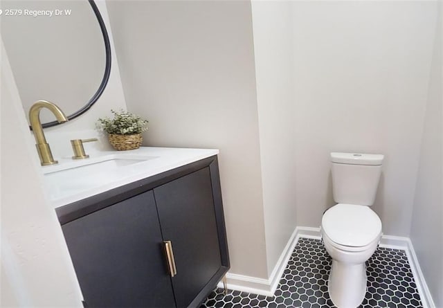 bathroom featuring vanity, tile patterned floors, and toilet