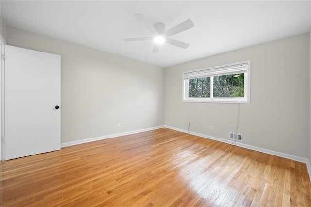 unfurnished room with ceiling fan and light wood-type flooring