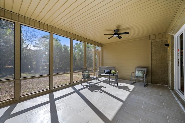 unfurnished sunroom featuring wooden ceiling and ceiling fan