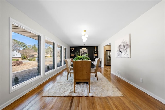 dining space with hardwood / wood-style flooring