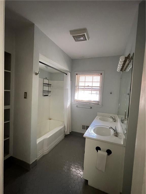 bathroom with a sink, visible vents, bathtub / shower combination, and double vanity