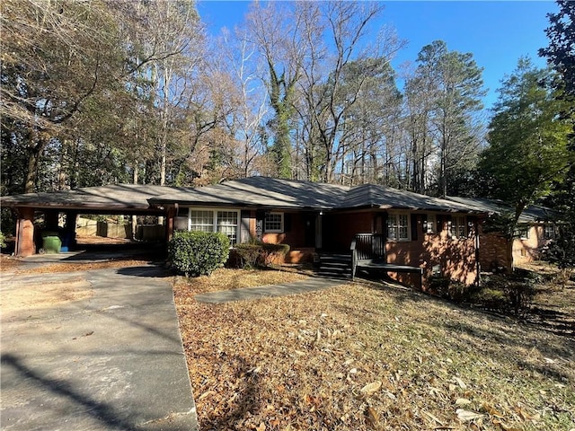 single story home with a carport and concrete driveway