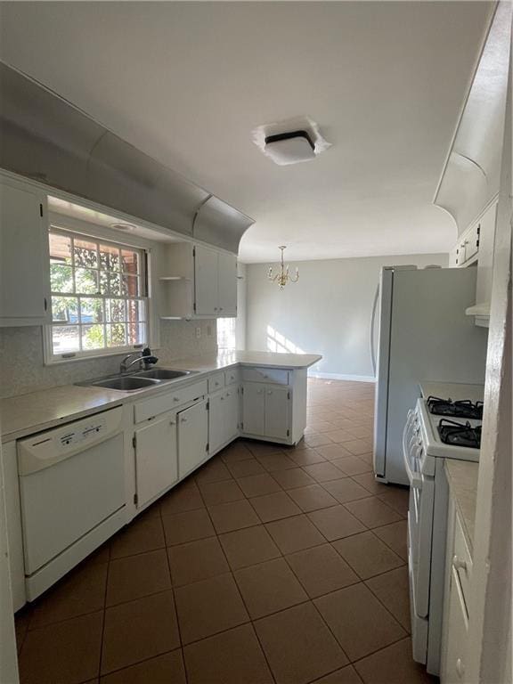 kitchen featuring dark tile patterned floors, a sink, open shelves, white cabinetry, and white appliances