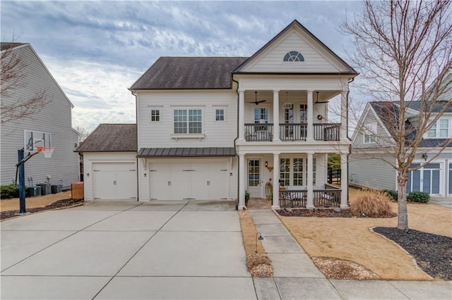 view of front of home with a garage, a balcony, a porch, and central AC unit