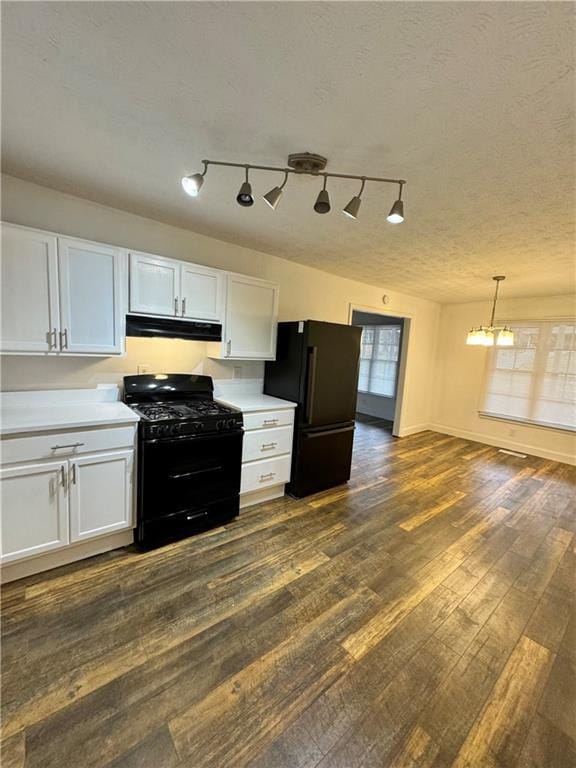 kitchen with dark hardwood / wood-style floors, white cabinets, hanging light fixtures, black appliances, and a textured ceiling