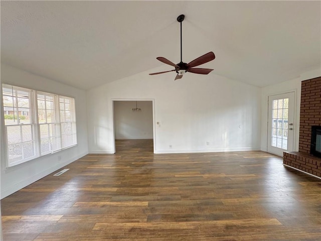 unfurnished living room with ceiling fan, dark hardwood / wood-style floors, vaulted ceiling, and a brick fireplace