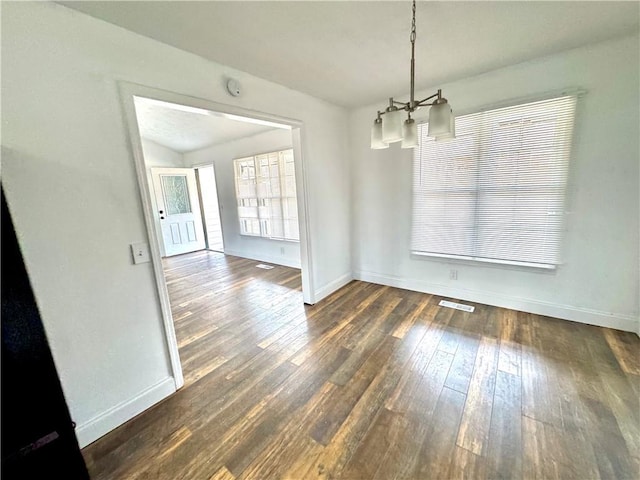 unfurnished dining area featuring dark hardwood / wood-style flooring